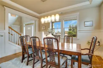 Dining for all! Fine craftsmanship radiates in the tray ceiling adorned with crown molding, the timeless bead board detailing, the rich warmth of hardwood floors, and an updated plate rail that elevates the space with style and elegance.