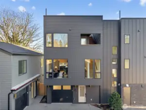 Welcome to your new construction home with a garage and rooftop deck views of Mount Rainier and Husky stadium.