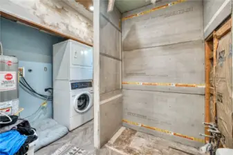 Main floor bathroom and laundry.  Shower is plumbed in and just needs to be completed with tile for a completed bath.
