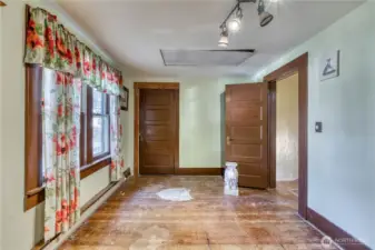 Bedroom with large windows, wood doors and large walk in closet.