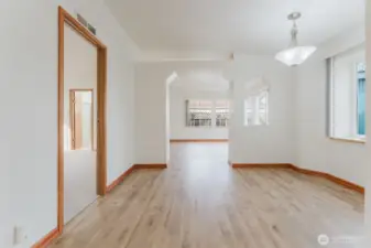 Dining area with primary bedroom door on the left. Den straight ahead.