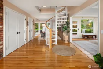 Spiral staircase provides second floor access with an updated wood trim.