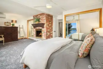 Primary bedroom with wood burning fireplace, new paint and carpeting and mini split for a warm, inviting environment.