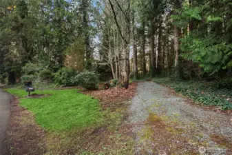 Homes additional cross street lot with room for a workshop, additional parking, or boat/RV storage. This homes shared well head is on this lot.