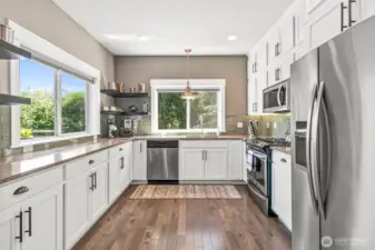 Spacious open kitchen with custom 9ft cabinetry offering abundant storage & ample conter space.