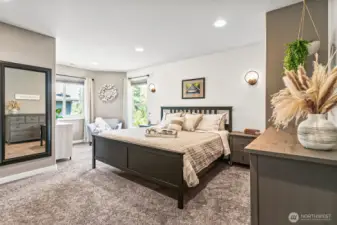 Expansive primary suite with elegant wall sconces, plush carpeting & a sitting area make for one luxurious retreat on the 2nd floor.