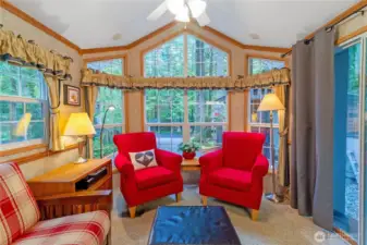 Another view of the living room showcasing the wall of windows.