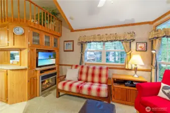 Entertainment center, electric fireplace, ample seating & loft above.