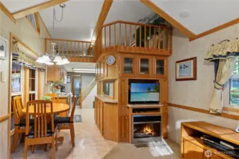 Open concept living & dining area w/ fireplace feature.