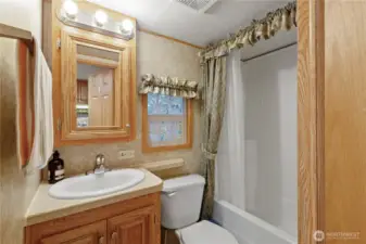 Full bathroom w/ vanity & storage.