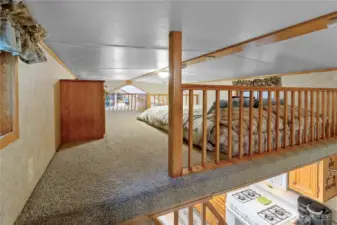 A view across the loft to the second area above the living room.