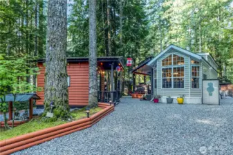 Exterior showing park model, shed & landscaped yard.