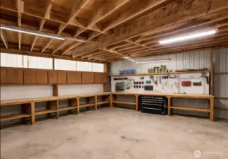So much storage & room for all your toys. This is the lower level of the garage. Currently housing items for moving but this picture shows what it will looks like at closing.