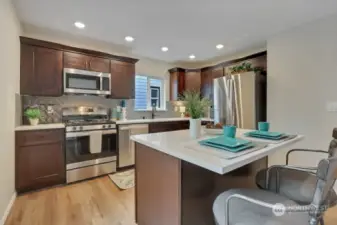 Kitchen w/New Cabinets, Laminate Floors, Full Tile Backsplash, Recessed Lighting and Great Island!