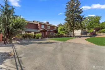 Additional gated entry onto brick driveway