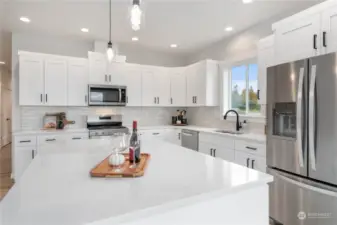 Granite countertops and tiled backsplash.