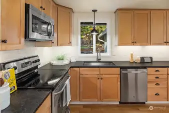 Updated kitchen with stone countertops.