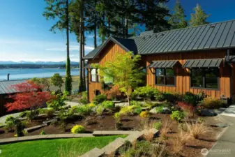 Step outside to the elegantly terraced gardens, which cascade gently towards the water, offering secluded nooks for intimate gatherings or quiet moments of solitude.