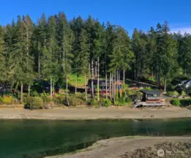 The property's design pays homage to the natural splendor that surrounds it, with rich wooden exteriors and large, luminous windows that capture the enchanting views from every angle.