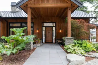 Covered walkway make this magnificent entry special with spectacular gardens and secluded waterfront wonderland.