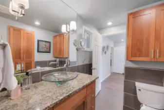 Primary bathroom boasts stunning remodel. Don't miss all the storage