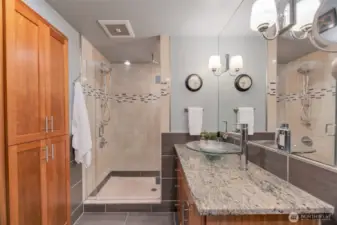 Primary bathroom. Oversized shower. Deep built in storage with outlets built in.
