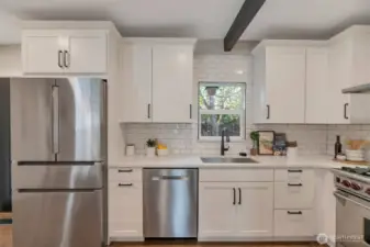 Quartz slab counters, custom backsplash, 'touchless' faucet and glass rinser.