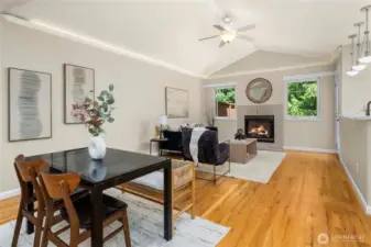 Vaulted ceilings and natural light enhance this open living and dining space