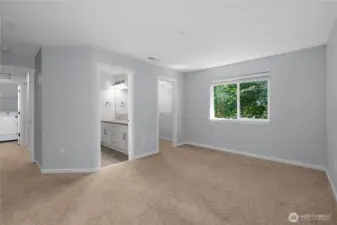 Primary bedroom looking towards the primary bathroom and walk-in closet