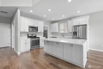 The kitchen features Whirpool appliances and a large walk in pantry.
