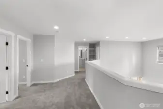 The upper lever features an open view of the living room and kitchen areas, with a spacious area between the individual rooms.
