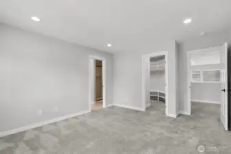 The primary bedroom features a walk in closet and elegant bathroom.