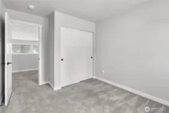The additional bedrooms feature sliding door closets for plenty of storage.