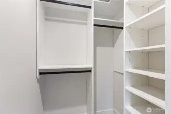This clean, built-in closet offers smart organization with open shelving and dual hanging rods—perfect for keeping essentials tidy and accessible.