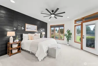 The primary suite is a true retreat with a custom shiplap wall, new ceiling fan, and access out to a private deck