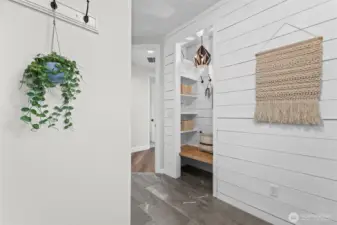 The laundry/mud room has the perfect spot to take off shoes and hang backpacks.