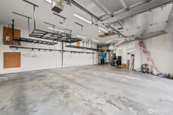 The three+ car garage is expansive, with plenty of overhead storage and a pull down ladder for attic access