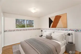 The primary bedroom is located in the back of the house and has an adjoining 1/2 bath.