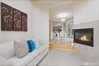 The sunroom just off the casual dining space is the perfect spot to enjoy a book by the fireplace.