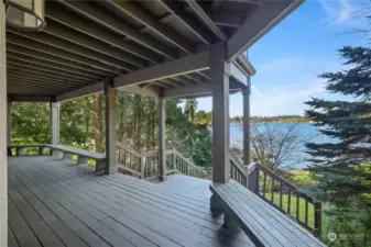 Bottom story back deck provides shade and yard access, with main level deck above, primary bed balcony above that.
