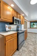 Another view of the kitchen area looking on into dining area and garden window