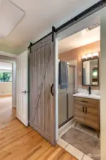 Barn door to primary bathroom