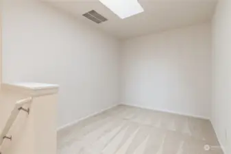 Loft area at the top of the stairs has a bright skylight - great space for home office, playroom, crafts, etc.