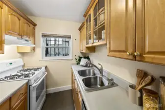 Kitchen has lots of counter space and a four burner gas cooktop.