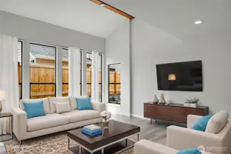 A wall of windows allows light to flood into this spacious living room. Virtually staged.
