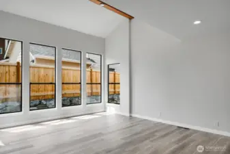 A wall of windows allows light to flood into this spacious living room.