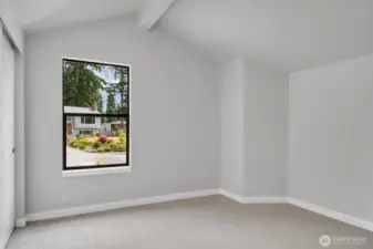 One of the upper level bedrooms with a vaulted ceiling and a secret room!