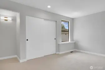 Second bedroom on the upper level with a niche perfect for a desk or vanity.