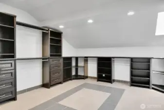 Vaulted Primary closet with heated tile floors and built ins! Go around the corner to the right.....