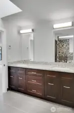 The primary bathroom also features a double vanity with ample storage space.